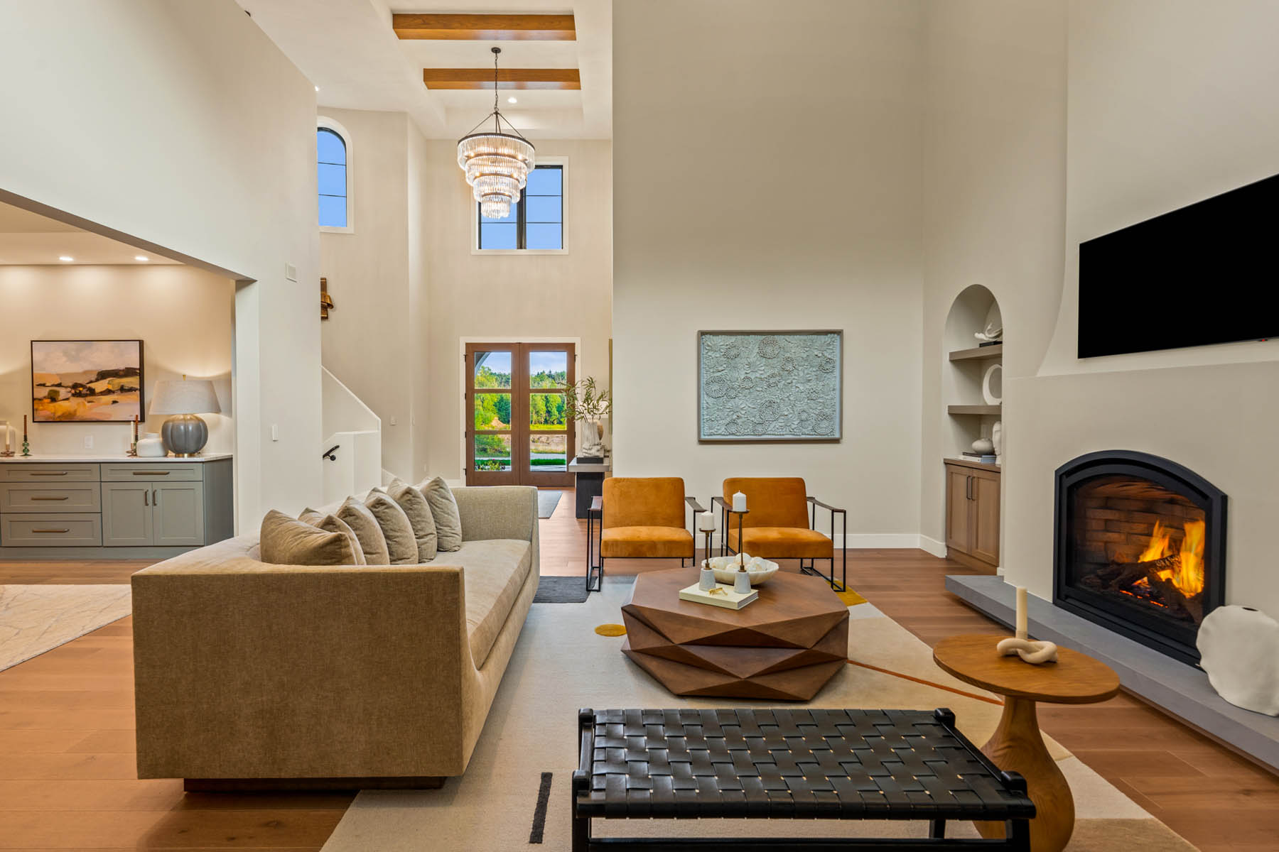 View of great room with 20 foot ceilings, fireplace and chandelier