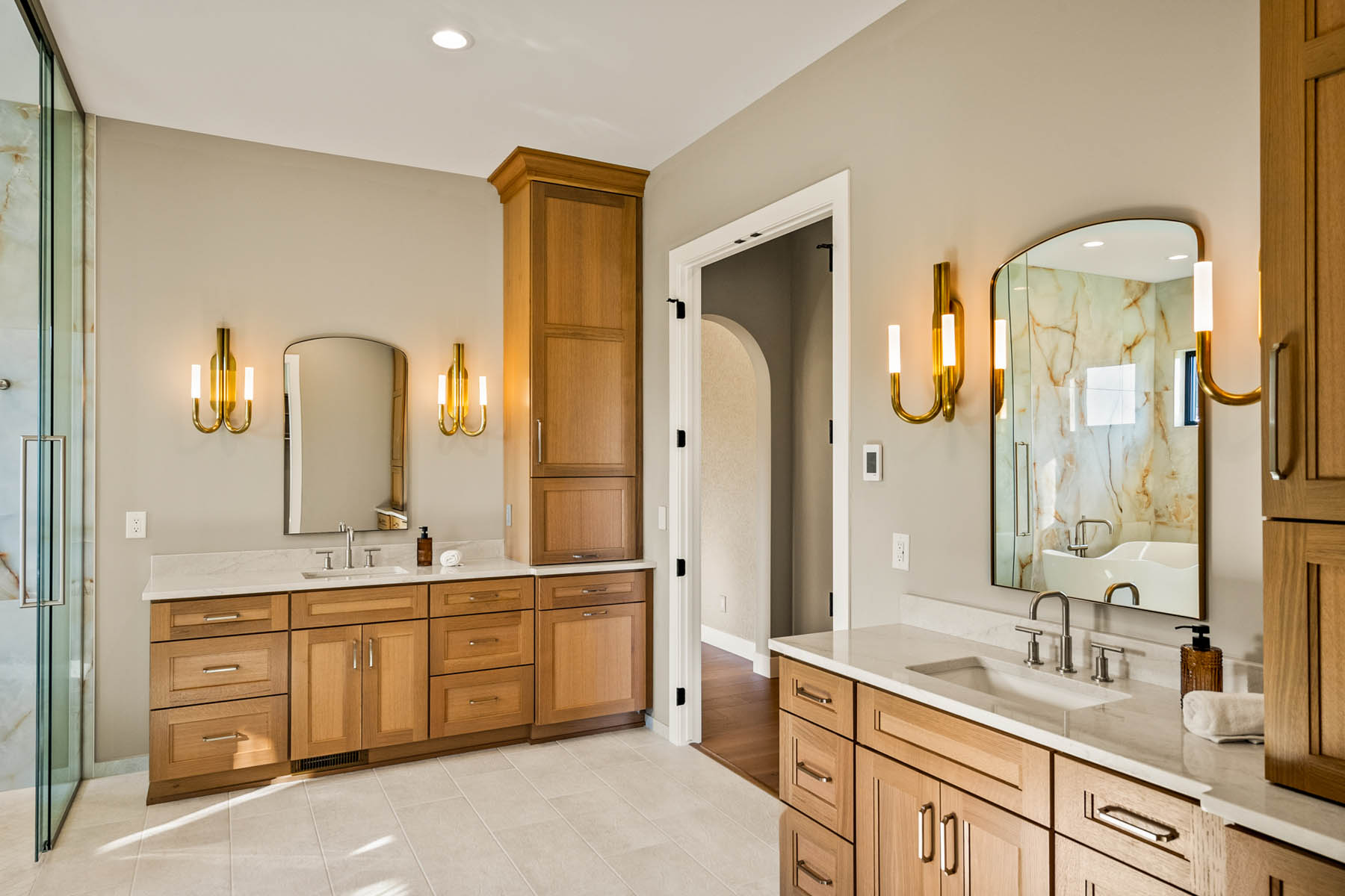 Primary suite master with separate vanities with built in linen towers