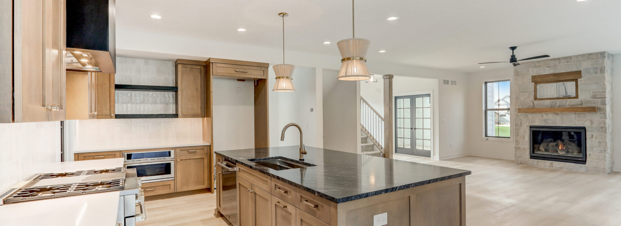modern kitchen and living room with fireplace